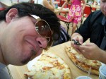 HUGE pizza and sexy shades.